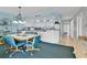 Open floor plan with kitchen, dining area, and ocean view from sliding glass doors at 1620 N Waccamaw Dr. # 103, Garden City Beach, SC 29576
