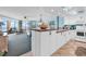 Bright condo living room with white kitchen, ocean view, and beachy decor at 1620 N Waccamaw Dr. # 103, Garden City Beach, SC 29576