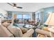 Bright living room featuring ocean views, comfortable seating, and a ceiling fan at 1620 N Waccamaw Dr. # 103, Garden City Beach, SC 29576