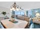 Open floor plan with living room, dining area, and ocean view from sliding glass doors at 1620 N Waccamaw Dr. # 103, Garden City Beach, SC 29576