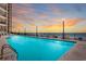 Large community pool with ocean views, deck chairs, and string lighting at this condo community at 1620 N Waccamaw Dr. # 103, Garden City Beach, SC 29576