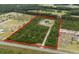 Aerial view of acreage featuring a home surrounded by lush greenery and mature trees at 1763 Hemingway Rd., Loris, SC 29569