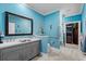 Elegant bathroom with a double sink vanity, blue walls, and a separate shower area at 1763 Hemingway Rd., Loris, SC 29569