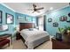 Comfortable bedroom with a cozy bed, a ceiling fan, and stylish coastal-themed wall decor at 1763 Hemingway Rd., Loris, SC 29569