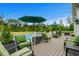 Relax on this outdoor deck with comfortable green seating, umbrellas, and views of the pool and lawn at 1763 Hemingway Rd., Loris, SC 29569
