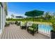 Relax on this outdoor deck with comfortable green seating, umbrellas, and views of the pool and lawn at 1763 Hemingway Rd., Loris, SC 29569