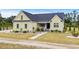 Charming yellow two-story home with landscaped yard and inviting front porch at 1763 Hemingway Rd., Loris, SC 29569