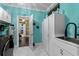 Well-lit laundry room with white cabinets, modern appliances, and stylish decor at 1763 Hemingway Rd., Loris, SC 29569