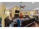 Bright living room offering a fireplace, hardwood floors, a ceiling fan, and comfortable seating at 1763 Hemingway Rd., Loris, SC 29569