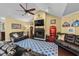 Spacious living room with vaulted ceilings, a fireplace, a ceiling fan, and leather furnishings at 1763 Hemingway Rd., Loris, SC 29569