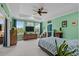 Comfortable main bedroom with large windows, a ceiling fan, and stylish decor at 1763 Hemingway Rd., Loris, SC 29569