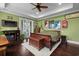 Spacious main bedroom featuring hardwood floors, a ceiling fan, and access to a balcony at 1763 Hemingway Rd., Loris, SC 29569