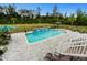In-ground pool with a patio, waterfall feature, and comfortable seating. Perfect for outdoor enjoyment at 1763 Hemingway Rd., Loris, SC 29569