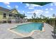 An in-ground pool with a tiled water feature, surrounded by stone pavers and greenery at 1763 Hemingway Rd., Loris, SC 29569