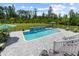 Beautiful in-ground pool with a tile waterfall feature and lush landscaping at 1763 Hemingway Rd., Loris, SC 29569