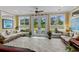 Sunroom with tile floors, large windows, and seating that looks out to the pool and greenery at 1763 Hemingway Rd., Loris, SC 29569