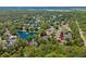 Aerial view showcases neighborhood homes surrounding a scenic lake with lush greenery at 190 Barony Pl., Pawleys Island, SC 29585