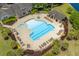 Aerial view of a community pool area with lounge chairs, tables, and shaded seating areas at 190 Barony Pl., Pawleys Island, SC 29585