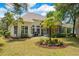 Large backyard featuring the home, a screened porch, and mature trees at 190 Barony Pl., Pawleys Island, SC 29585