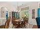 Well-lit dining room features a wooden table, chairs, and large windows overlooking the backyard at 190 Barony Pl., Pawleys Island, SC 29585