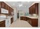 Spacious kitchen has ample counter space, wood cabinets, and a white appliance package at 190 Barony Pl., Pawleys Island, SC 29585