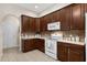 Kitchen with dark wood cabinets, neutral countertops, and standard appliances at 190 Barony Pl., Pawleys Island, SC 29585