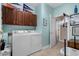 Functional laundry room with washer, dryer, storage cabinets, and access to an adjacent room at 190 Barony Pl., Pawleys Island, SC 29585