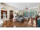 Well-lit living area with hardwood floors, a comfortable grey sofa, and a seamless transition to the kitchen at 190 Barony Pl., Pawleys Island, SC 29585