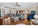 Bright and open living space with hardwood floors, a large sectional sofa, and views into the dining and kitchen areas at 190 Barony Pl., Pawleys Island, SC 29585