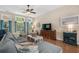 Spacious living room with hardwood floors, a comfortable seating arrangement, and an entertainment center at 190 Barony Pl., Pawleys Island, SC 29585