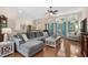 Comfortable living room featuring a large sectional sofa, a ceiling fan, and abundant natural light at 190 Barony Pl., Pawleys Island, SC 29585