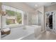 Bright main bathroom features a tub shower and a window providing lots of natural light at 190 Barony Pl., Pawleys Island, SC 29585