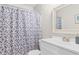 Clean bathroom features a shower with geometric curtain, mirror, and vanity at 2000 Greens Blvd. # 40C, Myrtle Beach, SC 29577