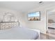 Bright bedroom featuring a TV, stylish dresser, and view to another bedroom at 2000 Greens Blvd. # 40C, Myrtle Beach, SC 29577