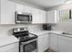 Modern kitchen featuring sleek white cabinetry, stainless steel appliances, and stylish countertops at 2000 Greens Blvd. # 40C, Myrtle Beach, SC 29577