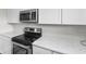Modern kitchen with white cabinets, stainless steel microwave and stove, and elegant countertops at 2000 Greens Blvd. # 40C, Myrtle Beach, SC 29577