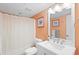 Bright bathroom with white vanity, framed mirror and shower with curtain at 201 Ocean Blvd. S # 1505, North Myrtle Beach, SC 29582