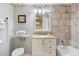 Bathroom featuring a single sink vanity, a bathtub with tile surround, and decorative accents at 201 Ocean Blvd. S # 1505, North Myrtle Beach, SC 29582