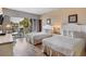 Cozy bedroom featuring two twin beds, a nightstand, and access to a balcony at 201 Ocean Blvd. S # 1505, North Myrtle Beach, SC 29582