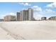 Expansive view of a condominium complex set against a sandy beach, showcasing its beachfront location at 201 Ocean Blvd. S # 1505, North Myrtle Beach, SC 29582