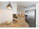 A view of the kitchen featuring granite countertops, stainless steel appliances, and tiled floors at 201 Ocean Blvd. S # 1505, North Myrtle Beach, SC 29582