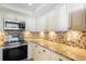 Bright kitchen showcasing granite countertops, decorative backsplash, stainless steel appliances, and ample cabinet storage at 201 Ocean Blvd. S # 1505, North Myrtle Beach, SC 29582