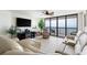 Spacious living room featuring comfortable seating, a fireplace, and access to a balcony with ocean views at 201 Ocean Blvd. S # 1505, North Myrtle Beach, SC 29582