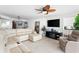 Open-concept living room with tile floors, comfortable couches, fireplace and large TV at 201 Ocean Blvd. S # 1505, North Myrtle Beach, SC 29582