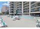 Relaxing pool area with tables, chairs and umbrellas for leisurely days at 201 Ocean Blvd. S # 1505, North Myrtle Beach, SC 29582