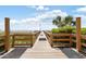 Wooden walkway leading to the beach with showers and greenery at 201 Ocean Blvd. S # 1505, North Myrtle Beach, SC 29582