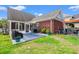 Brick home featuring a patio with table set, and sunroom, for outdoor dining and relaxation at 2019 Ye Olde Kings Hwy., North Myrtle Beach, SC 29582