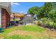 Well-maintained backyard featuring a storage shed with American flag, near outdoor dining area at 2019 Ye Olde Kings Hwy., North Myrtle Beach, SC 29582