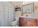 Bathroom featuring a dark wood vanity with marble countertop and a decorative mirror above at 2019 Ye Olde Kings Hwy., North Myrtle Beach, SC 29582