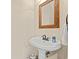 Powder room featuring a pedestal sink, a decorative mirror, and a towel rack at 2019 Ye Olde Kings Hwy., North Myrtle Beach, SC 29582